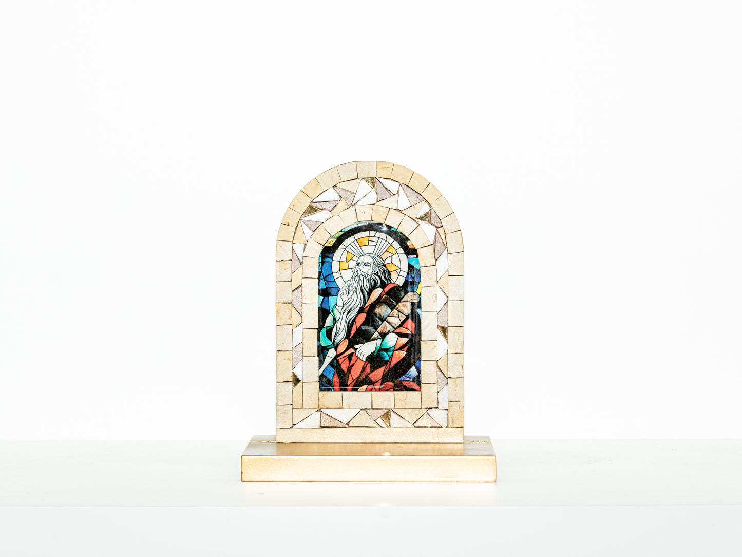Mosaic artwork with a religious figure in a frame on a white background
