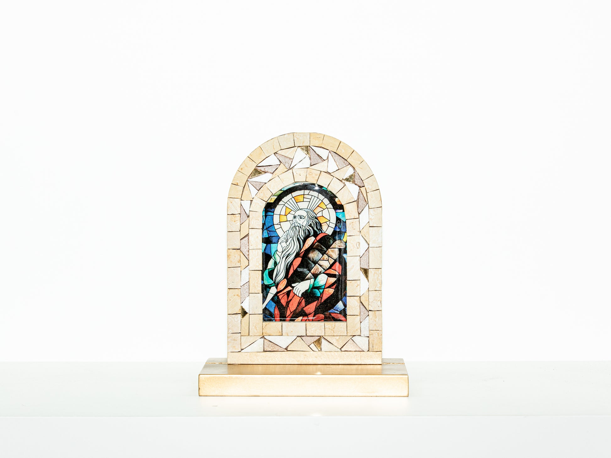 Mosaic artwork with a religious figure in a frame on a white background